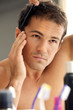 Young man combing his hair