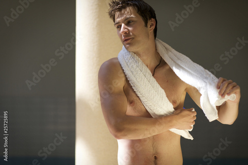 Photo: Portrait of a young man on swimming pool Portrait of a young man on swimming pool
