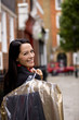A businesswoman carrying her dry cleaning