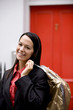 A businesswoman carrying her dry cleaning