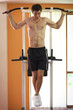 Man hanging on pull up bar Man hanging on pull up bar