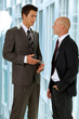 Portrait of young caucasian business people talking in office