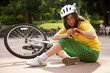 Young woman injured and clutching arm