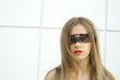 Beautiful fashionable girl. Blindfolded black lace ribbon