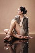 Fashionable brunette on mirrored floor