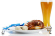 weisswürste mit bier brezel auf einem teller mit geschirrtuch