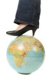 Foot on globe