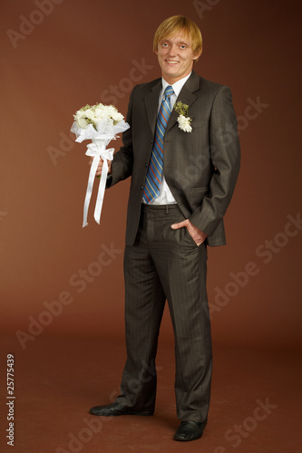 Photo: Happy groom with bouquet Happy groom with bouquet