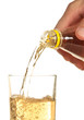 man's hand pours a drink into a glass