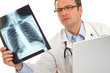 Male doctor examining an x-ray image Male doctor examining an x-ray image