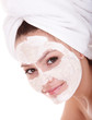 Girl with clay facial mask. Isolated.