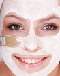 Girl with clay facial mask.