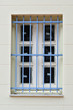 Protective metal bars. Dirty window of renovated building Protective metal bars. Dirty window of renovated building