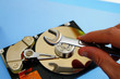 PC technician repairing a  computer hard-drive
