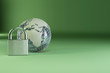 Earth with padlock on green background