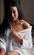 Young brunette woman in her bedroom