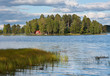 Island on lake in Finland with red summer cottage Island on lake in Finland with red summer cottage