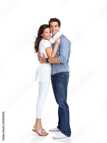 Photo: Happy young couple embracing each other on white Happy young couple embracing each other on white