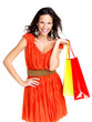 Stunning young woman carrying shopping bags against white