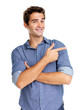 Happy young man pointing at copyspace on white