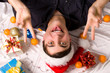 Photo: man in red hat lie among gift boxes man in red hat lie among gift boxes
