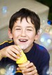 Photo: A Boy Playing With Bubbles A Boy Playing With Bubbles