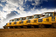 Row of yellow heavy tipper trucks Row of yellow heavy tipper trucks