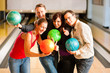 Friends bowling together Friends bowling together