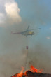 Fire rescue helicopter draining water over fire Fire rescue helicopter draining water over fire