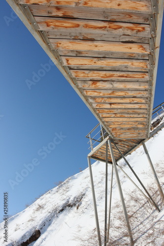 Photo: Stairs with landing against a snow slope Stairs with landing against a snow slope