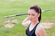 Determined female athlete ready to throw javelin Determined female athlete ready to throw javelin