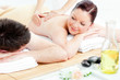 Caucasian young couple receiving a back massage Caucasian young couple receiving a back massage