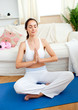 Young woman meditating in her living-room