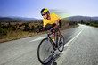 Photo: Cyclist riding a bike on an open road Cyclist riding a bike on an open road