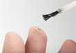 applying medicine to treat a wart