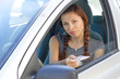 Beautiful woman show her driver's  licence in car