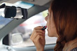 Beautiful Woman do put on make-up in car