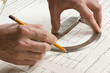 hand draws a pencil on drawing