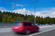 Photo: Fast driving red car on high way - motion blur Fast driving red car on high way - motion blur