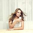Beautiful girl with glass of milk