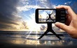 Camera mobile phone and happy jumping man