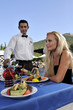 Waiter serving wine in a gourmet restaurant.