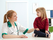 female doctor with young girl in exam room