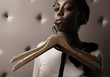 African woman with hangers trailing for a her lip