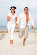 Photo: Beach couple running Beach couple running