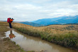 Photographer, paddle and autumn mountains