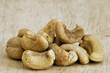 Heap of a roasted cashew nuts on an old wooden table.