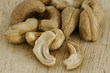 Heap of a roasted cashew nuts on an old wooden table.