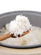 rice in the wooden spoon & cooker isolated on white background