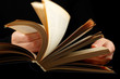 Looking thruogh book with motion blur on black background Looking thruogh book with motion blur on black background